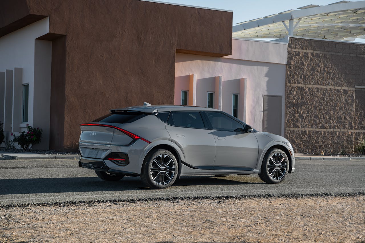 Sleek Kia EV6 GT-Line parked outside a modern building, showcasing futuristic design and innovation.